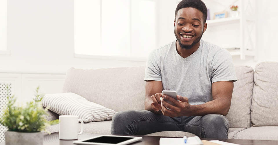 Young man using a smartphone to get a personal loan