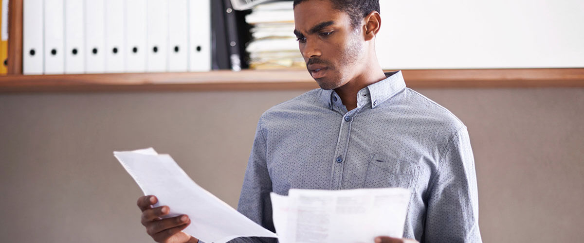 Man looking over credit reports and wondering what is a tradeline?