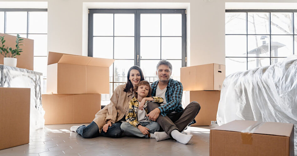 family in room with moving boxes