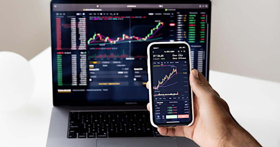 stock price analysis charts on laptop and phone